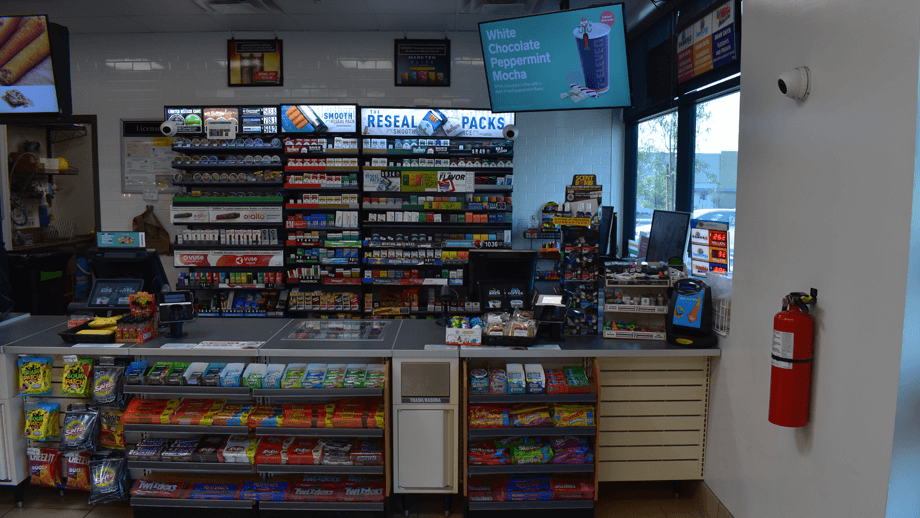 Indoor image of 7-11 showing the hot foods display and condiment area.